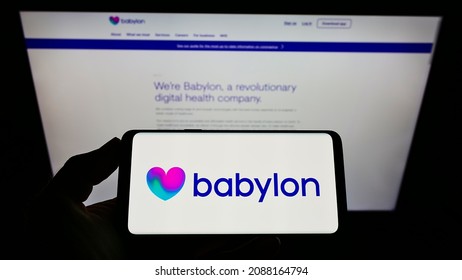 Stuttgart, Germany - 06-20-2021: Person Holding Smartphone With Logo Of British Healthcare Company Babylon Health On Screen In Front Of Website. Focus On Phone Display. Unmodified Photo.