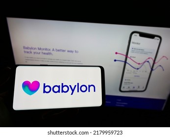 Stuttgart, Germany - 06-20-2021: Person Holding Mobile Phone With Logo Of British Healthcare Company Babylon Health On Screen In Front Of Business Web Page. Focus On Phone Display. Unmodified Photo.