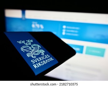 Stuttgart, Germany - 07-16-2022: Mobile phone with logo of Swedish central bank Sveriges Riksbank on screen in front of website. Focus on center of phone display. Unmodified photo.