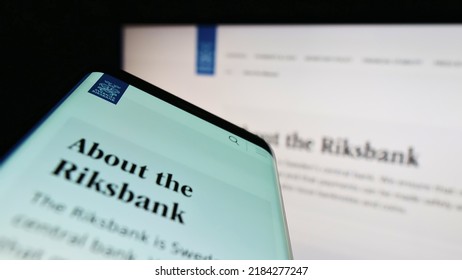 Stuttgart, Germany - 07-16-2022: Mobile phone with website and logo of Swedish central bank Sveriges Riksbank on screen. Focus on top-left of phone display. Unmodified photo.