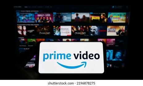 Stuttgart, Germany - 07-16-2022: Person Holding Smartphone With Logo Of Streaming Service Amazon Prime Video On Screen In Front Of Website. Focus On Phone Display. Unmodified Photo.