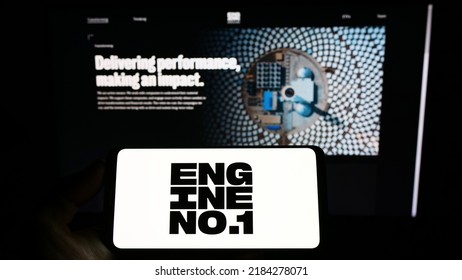 Stuttgart, Germany - 07-24-2022: Person holding smartphone with logo of US investment company Engine No. 1 LP on screen in front of website. Focus on phone display. Unmodified photo.