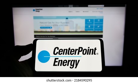 Stuttgart, Germany - 07-24-2022: Person Holding Smartphone With Logo Of US Utility Company CenterPoint Energy Inc. On Screen In Front Of Website. Focus On Phone Display. Unmodified Photo.