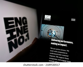 Stuttgart, Germany - 07-24-2022: Person holding cellphone with website of US investment company Engine No. 1 LP on screen in front of logo. Focus on center of phone display. Unmodified photo.