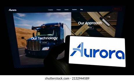 Stuttgart, Germany - 07-31-2021: Person Holding Smartphone With Logo Of Self-driving Vehicle Company Aurora Innovation Inc. On Screen In Front Of Website. Focus On Phone Display. Unmodified Photo.