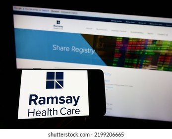 Stuttgart, Germany - 08-27-2022: Person Holding Mobile Phone With Logo Of Australian Company Ramsay Health Care Limited On Screen In Front Of Web Page. Focus On Phone Display. Unmodified Photo.