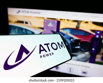 Stuttgart, Germany - 08-28-2022: Mobile Phone With Logo Of US Electric Charging Company Atom Power Inc. On Screen In Front Of Website. Focus On Center-right Of Phone Display. Unmodified Photo.