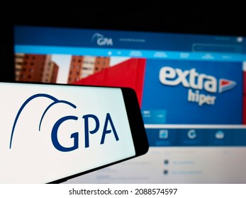 Stuttgart, Germany - 08-29-2021: Mobile phone with logo of company Companhia Brasileira de Distribuição (GPA) on screen in front of website. Focus on center-left of phone display. Unmodified photo.