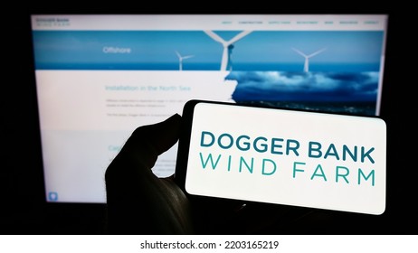 Stuttgart, Germany - 09-11-2022: Person Holding Mobile Phone With Logo Of Offshore Energy Generator Dogger Bank Wind Farm On Screen In Front Of Web Page. Focus On Phone Display. Unmodified Photo.