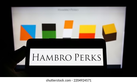 Stuttgart, Germany - 09-13-2022: Person Holding Cellphone With Logo Of British Investment Company Hambro Perks Limited On Screen In Front Of Webpage. Focus On Phone Display. Unmodified Photo.