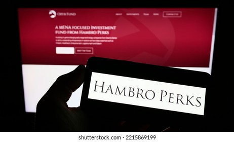 Stuttgart, Germany - 09-13-2022: Person Holding Smartphone With Logo Of British Investment Company Hambro Perks Limited On Screen In Front Of Website. Focus On Phone Display. Unmodified Photo.