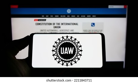 Stuttgart, Germany - 09-30-2022: Person Holding Cellphone With Logo Of American Trade Union United Auto Workers (UAW) On Screen In Front Of Webpage. Focus On Phone Display. Unmodified Photo.