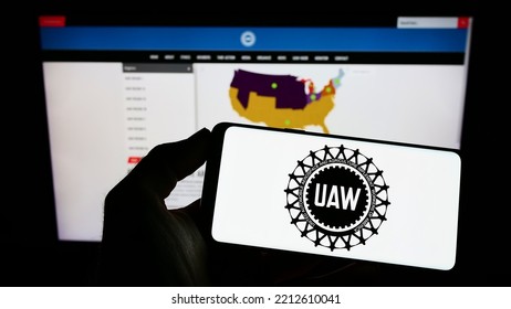 Stuttgart, Germany - 09-30-2022: Person Holding Mobile Phone With Logo Of US Trade Union United Auto Workers (UAW) On Screen In Front Of Web Page. Focus On Phone Display. Unmodified Photo.