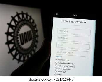 Stuttgart, Germany - 09-30-2022: Person Holding Cellphone With Webpage Of US Trade Union United Auto Workers (UAW) On Screen In Front Of Logo. Focus On Center Of Phone Display. Unmodified Photo.