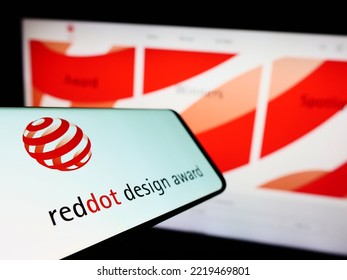 Stuttgart, Germany - 10-15-2022: Mobile Phone With Logo Of German International Prize Red Dot Design Award On Screen In Front Of Website. Focus On Left Of Phone Display. Unmodified Photo.