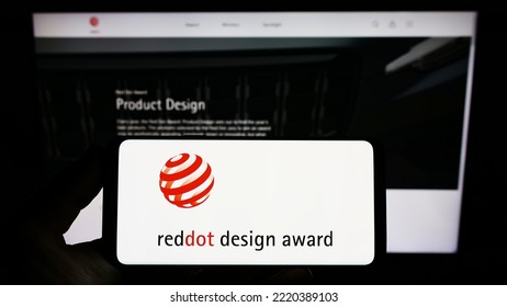 Stuttgart, Germany - 10-15-2022: Person Holding Smartphone With Logo Of German International Prize Red Dot Design Award On Screen In Front Of Website. Focus On Phone Display. Unmodified Photo.