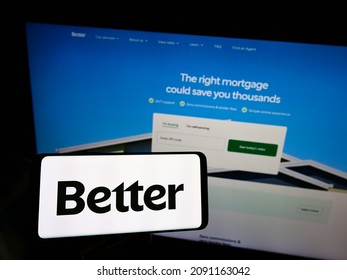Stuttgart, Germany - 12-11-2021: Person holding smartphone with logo of US financial company Better Mortgage (Better.com) on screen in front of website. Focus on phone display. Unmodified photo.