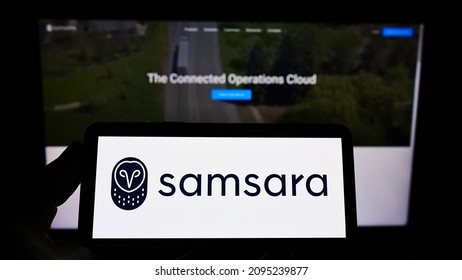 Stuttgart, Germany - 12-11-2021: Person holding smartphone with logo of US cloud software company Samsara Inc. on screen in front of website. Focus on phone display. Unmodified photo.