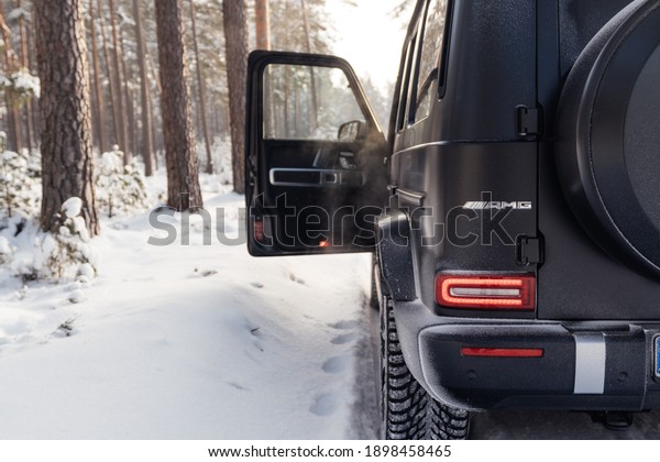 Stuttgart, Germany 19 January 2021,\
Mercedes-Benz G-Class (W463) Geländewagen G63 AMG Winter time in\
snowily forest Driver door open black SUV car in snow forest road.\
Holiday Trip Drive to\
wonderland