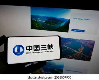 STUTTGART, GERMANY - Aug 16, 2021: Person holding mobile phone with logo of power company China Three Gorges Corporation (CTG) on screen in front of web page  Focus on phone display 