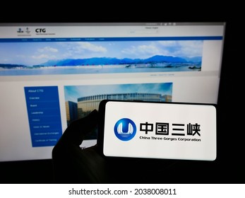STUTTGART, GERMANY - Aug 16, 2021: Person holding cellphone with logo of power company China Three Gorges Corporation (CTG) on screen in front of webpage  Focus on phone display 