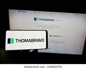 STUTTGART, GERMANY - Dec 13, 2021: Person Holding Cellphone With Logo Of US Company Thoma Bravo L P  On Screen In Front Of Webpage  Focus On Phone Display 