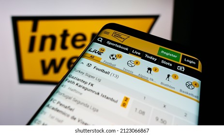 STUTTGART, GERMANY - Jan 08, 2022: Mobile Phone With Webpage Of Sports Betting Company Interwetten Ltd  On Screen In Front Of Business Logo  Focus On Top-left Of Phone Display 