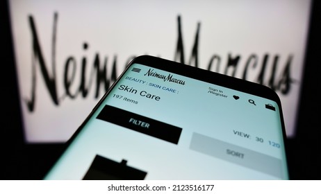 STUTTGART, GERMANY - Jan 09, 2022: Mobile Phone With Webpage Of American Luxury Retailer Neiman Marcus Group Inc  On Screen In Front Of Logo  Focus On Top-left Of Phone Display 