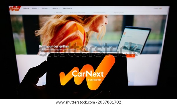 STUTTGART, GERMANY -\
Jul 12, 2021: Person holding smartphone with logo of company\
LeasePlan Corporation N V  (CarNext com) on screen in front of\
website  Focus on phone display\
