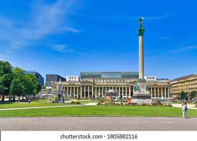 Stuttgart, Germany - July 2020: Public park in town square called 'Schlossplatz' in old city center with monument column and shopping mall on sunny day
