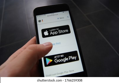 Stuttgart, Germany - June 18, 2020: Corona Warn App Website Of The German Federal Government On A Smartphone Showing Download Options Of Apple's App Store And The Google App Store. 