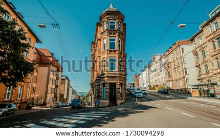 Stuttgart, Germany, June, 2015, Flat building in center of street inside stuttgart city at Eugensplatz square, a popular meeting place for people. Architecture reminding of flatiron building in New Yo