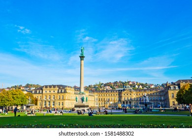 Stuttgart, Germany - October  2019: People are walking and resting on the Schlossplatz plaza in Stuttgart, near the New Palace, which was built between 1746 and 1807.