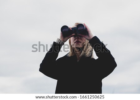 Similar – Blonde woman with black dress and sunglasses performing dance in nature with backlight