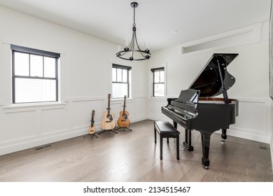 Styled Interior Of Music Room. Empty Room With Grand Piano, Guitars And Ukulele. Private Music Lesson Room.