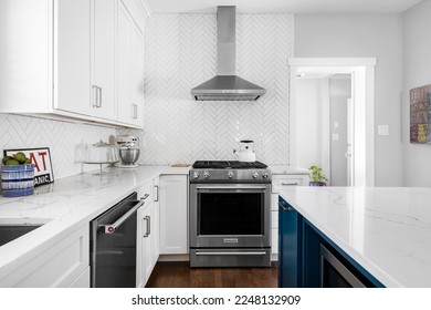 Styled Kitchen Interior. Stylish White Neutral Kitchen. White Cabinets with Stainless Steel Appliances and Tile Backsplash. Kitchen Interior Design.