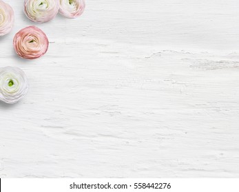 Styled stock photo. Feminine desktop mockup with ranunculus flowers, empty space and shabby white backround. Top view. Picture for blog or social media.