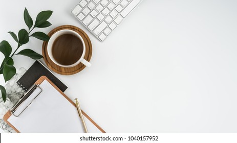 Styled stock photography white office desk table with blank notebook, computer, supplies and coffee cup. Top view with copy space. Flat lay. - Shutterstock ID 1040157952