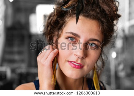Stylish accessories. Stylish modern dark-haired blue-eyed woman with piercing in her nose wearing stylish accessories