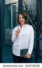 Stylish adult woman in classic white shirt. Happy successful woman. Semi-casual style. Portrait of businesswoman.