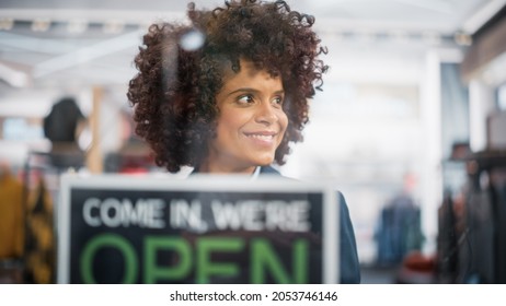 Stylish African American Clothing Shop Manager Changes Fashion Store Sign on the Door to Open. Professional Shop Sales Retail Assistant Working. Small Business Owner at Shopping Mall. - Powered by Shutterstock