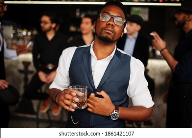 Stylish african american man against group of handsome retro well-dressed guys gangsters spend time at club, drinking on bar counter. Multiethnic male bachelor mafia party in restaurant.
