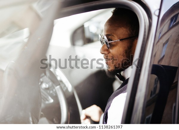 Stylish african man in car. back view of\
stylish african american man sitting in\
car.