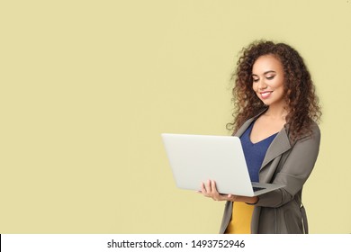 Stylish African-American Woman With Laptop On Color Background