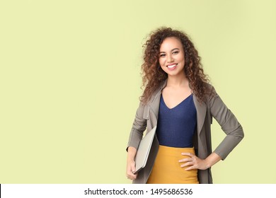 Stylish African-American Woman With Laptop On Color Background