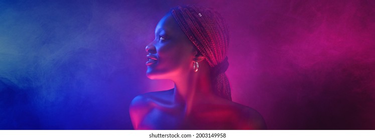 Stylish Afro Girl Portrait Near Pink Blue Neon Light Sign. Portrait In Cool Neon Light.