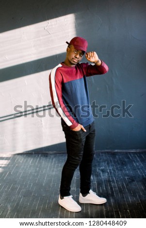 Black young man listening to music in a sunny day