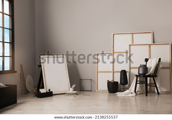 Stylish\
artist\'s studio interior with canvas and\
brushes