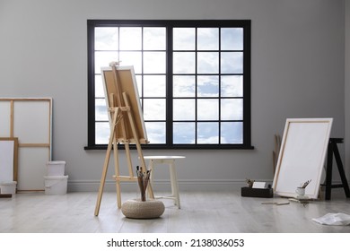 Stylish Artist's Studio Interior With Easel And Brushes