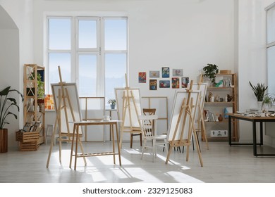 Stylish artist's studio interior with easels and canvases. Creative hobby - Powered by Shutterstock